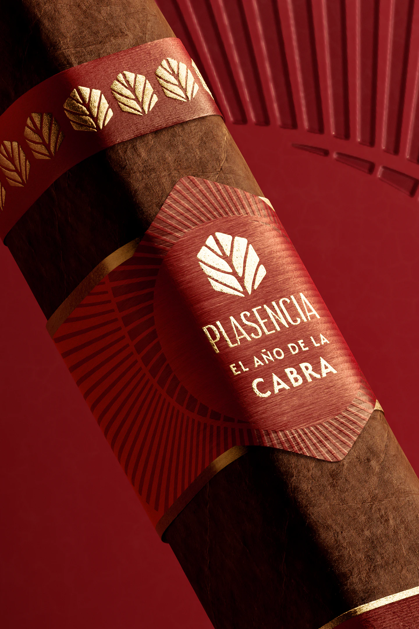The El Año de la Cabra bands close up, the gold leaves and the hexagon on red, the goat horn spiral behind