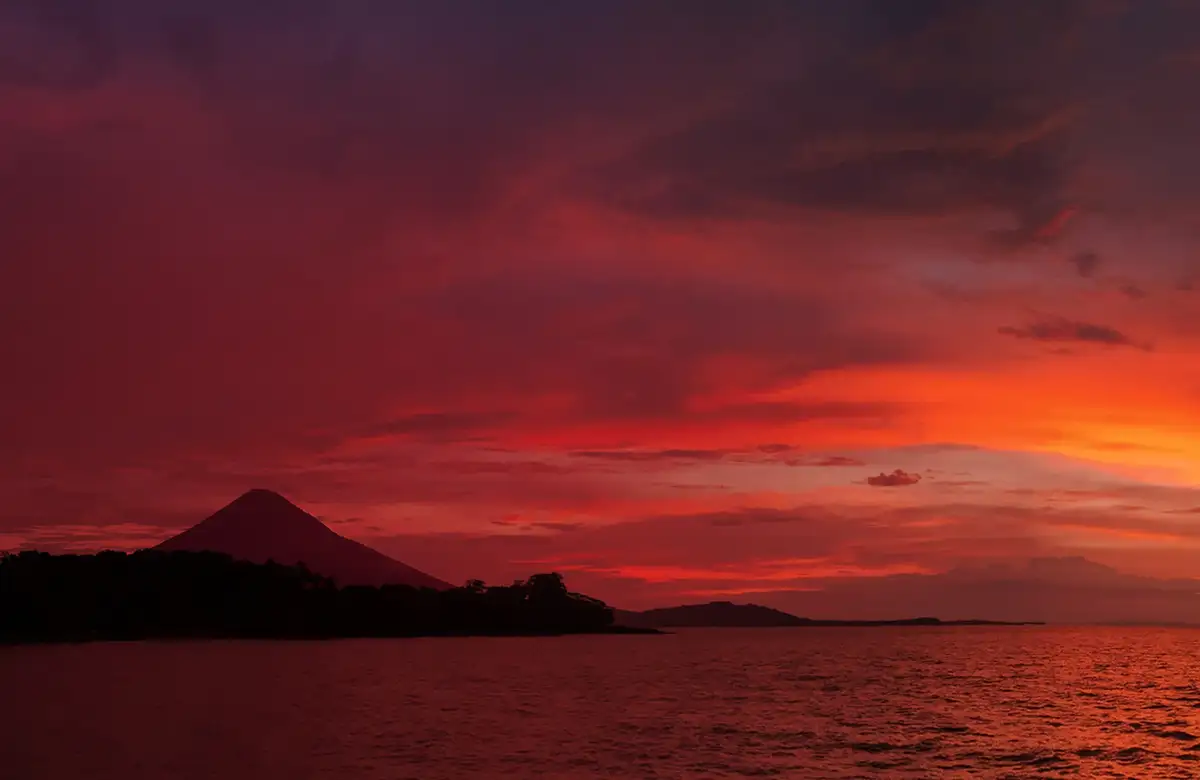 The volcano of Ometepe against a red sunset over the lake