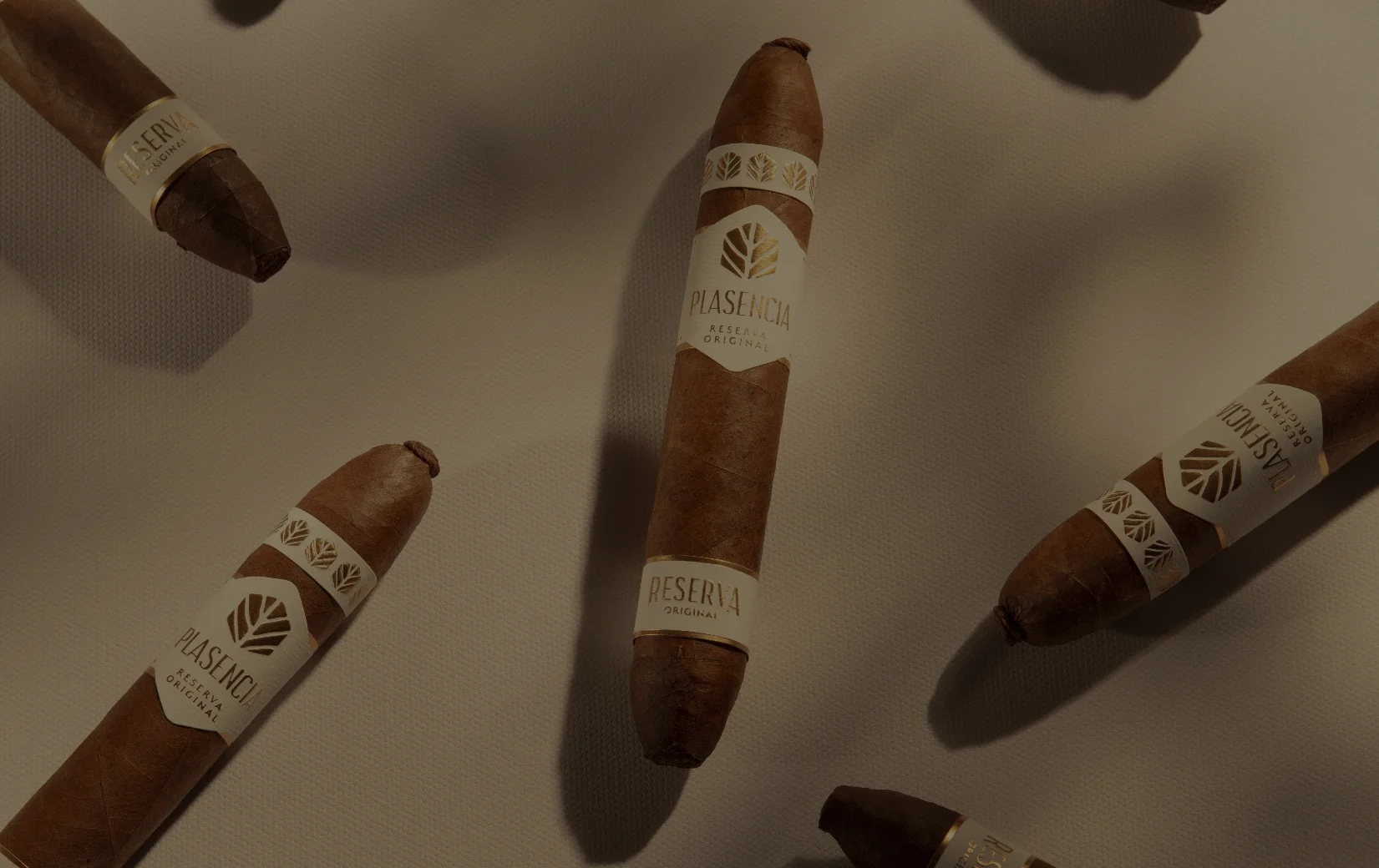 Reserva Original cigars scattered on pale sand cloth