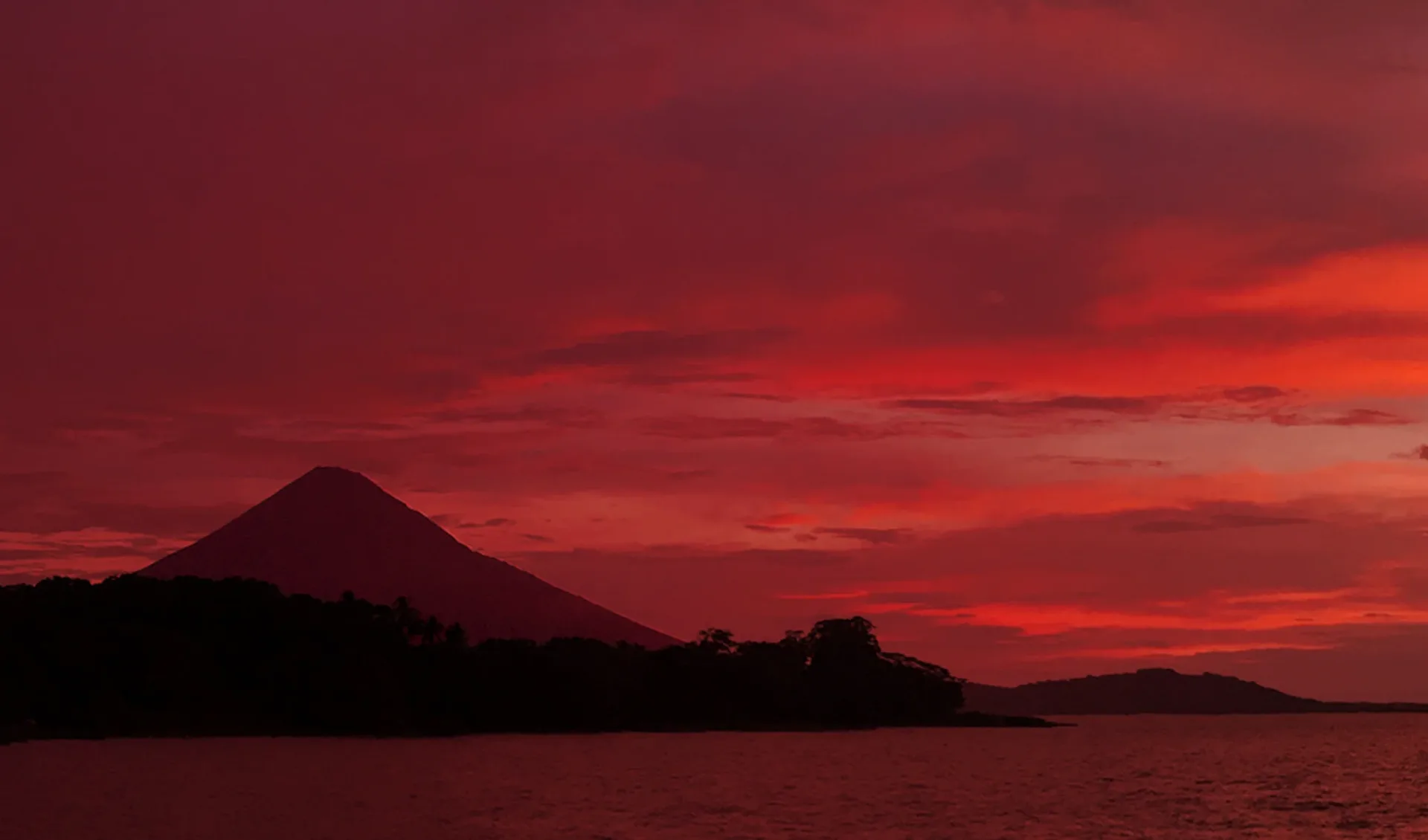 Sunset over Lake Nicaragua, a volcano of the island of Ometepe on the horizon